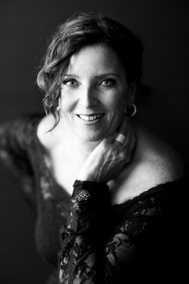 Elegant black and white portrait of Laura with off-shoulder lace top, part of 40 over 40 project