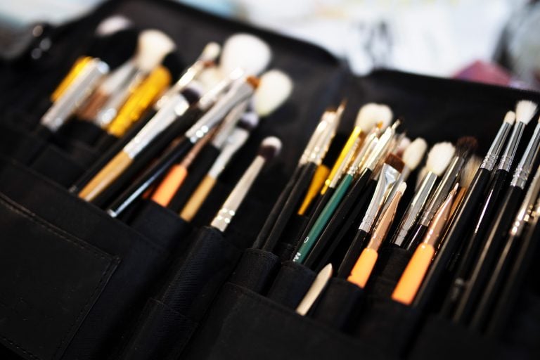 Close-up of professional makeup brushes organized in a makeup artist’s kit at Massen Photography