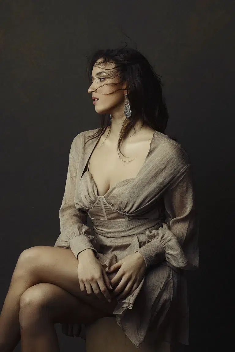 Studio portrait of a woman in a beige dress with soft natural lighting and calm expression, photographed by Massen Photography Luxembourg.