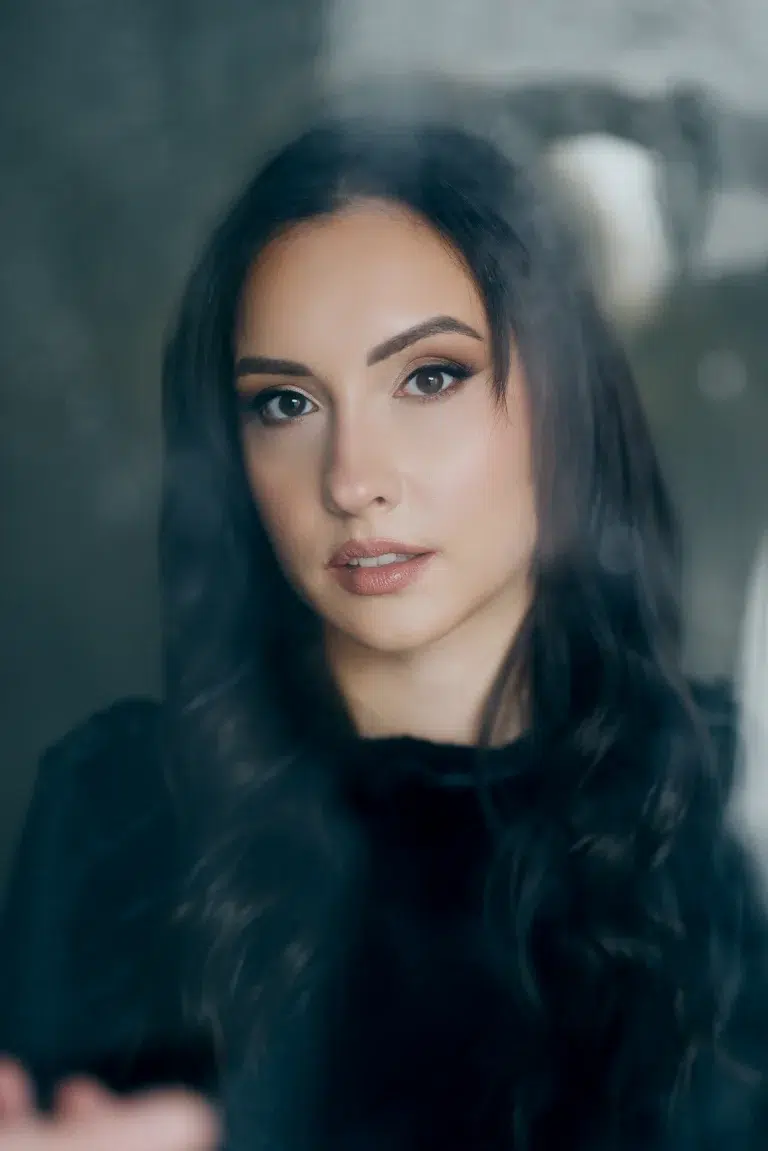 Window light beauty portrait of a woman with dark hair in Luxembourg