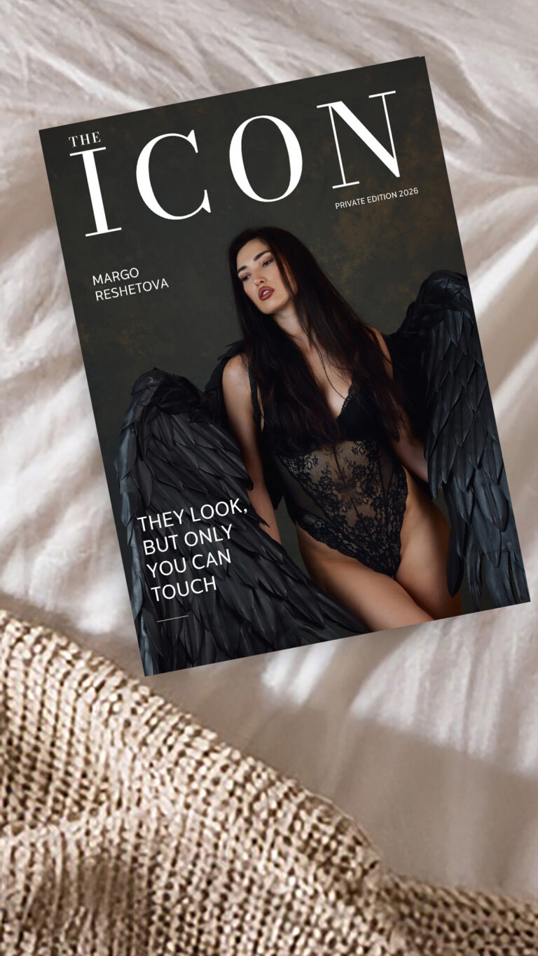 Boudoir portrait styled as a private-edition magazine cover, with black wings and dramatic lighting