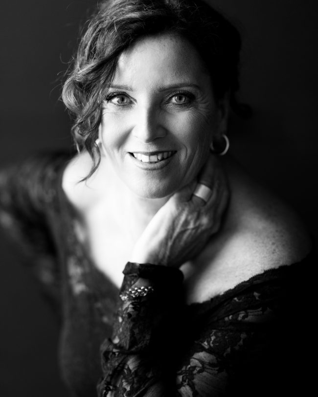 Elegant black and white portrait of Laura with off-shoulder lace top, part of 40 over 40 project