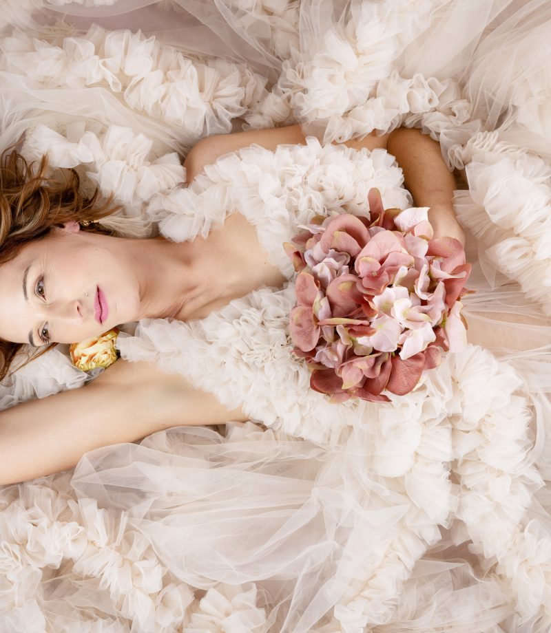 Artistic portrait of Martine lying in soft tulle with flowers, dreamy and feminine 40 over 40 image